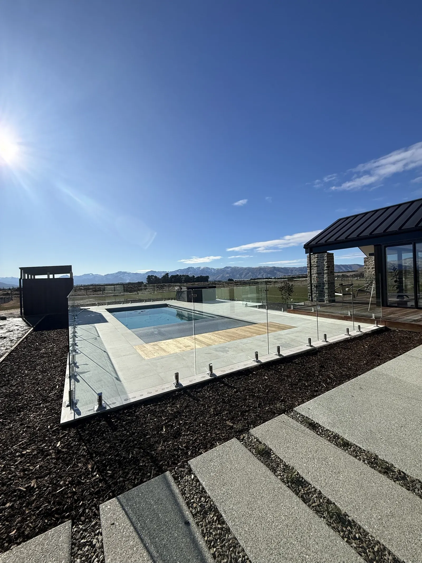Wanaka: frameless glass pool fence with mountain views, by TK Glass NZ